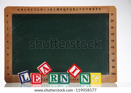 close up of the alphabet blocks in front of the black board
