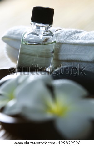 massage oil and towel on the bamboo background