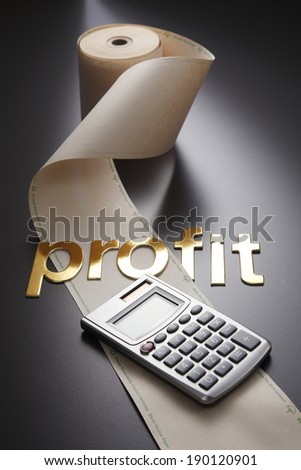 adding machine tape  and calculator with word profit