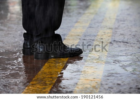 raining day man stand in the middle of road