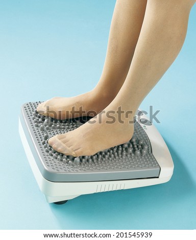 foot resting on the foot massaging machine