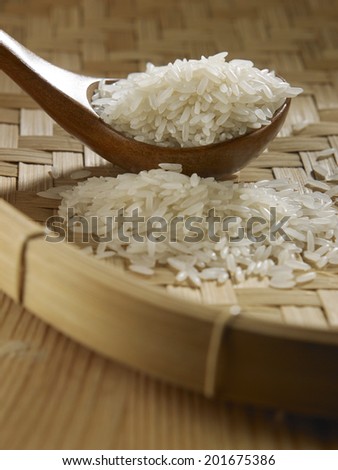 spoon full of rice on bamboo tray
