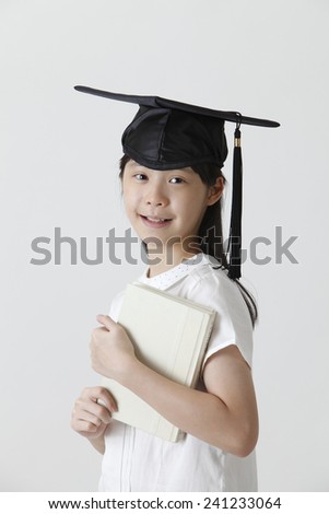 girl with the mortar board holding book