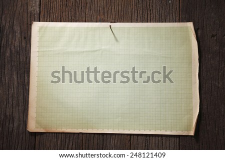 old paper nail on wood background