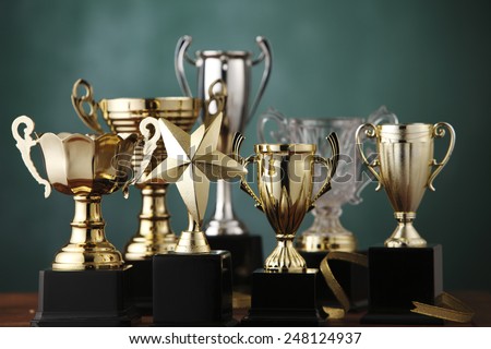 Group of the trophies on the green background