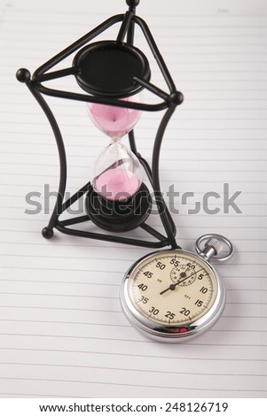 the contrast of the old hour glass and the stopwatch