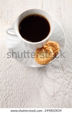 top view of black coffee and biscuits