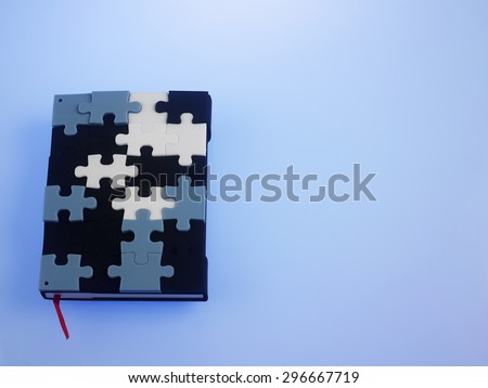jigsaw puzzle note book on the blue background