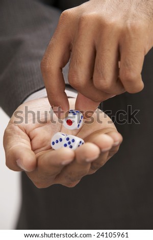 close up of man picking up a dice