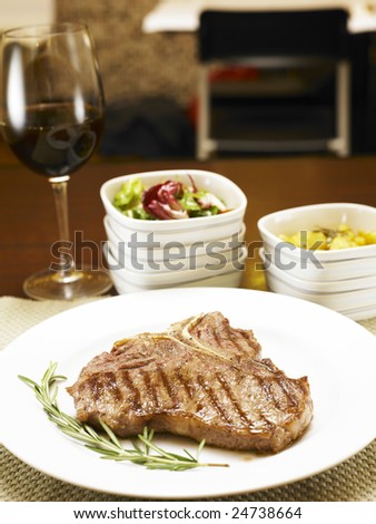 string steak and red wine at restaurant with table setting