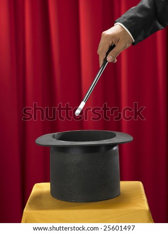 magician with the stick in front of top hat