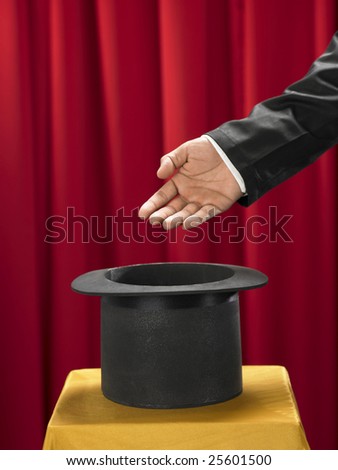 magician with the a hand in front of top hat