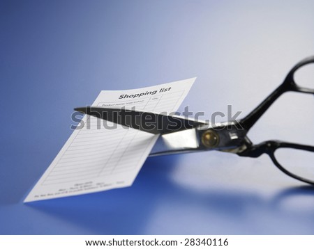 a pair of scissors cut away the shopping list
