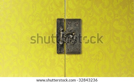 hinge on the box with lock on the yellow texture background