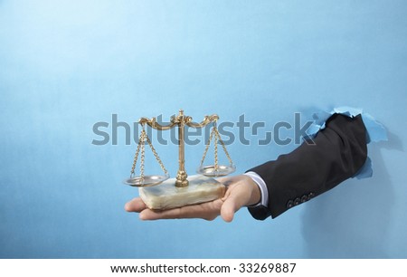 hand holding a balance scale