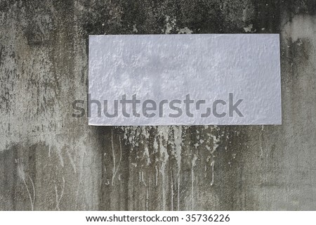 blank poster  on the weathered wall on the street