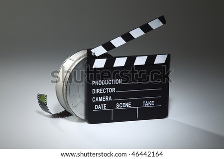 clapperboard and the film reel on the plain background