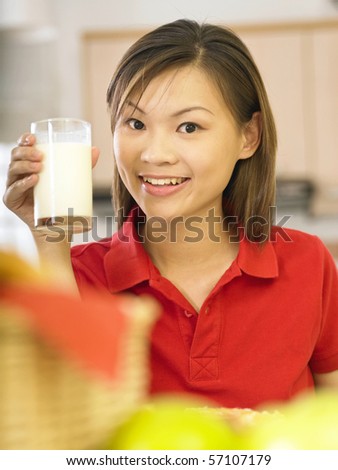 woman drinking milk in kitchen
