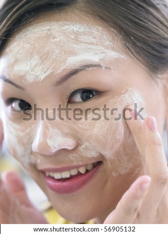 young lady washing her face
