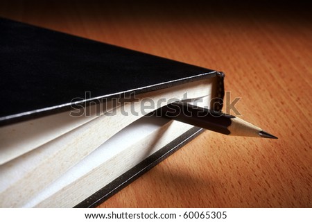 pencil in the closed book as book mark