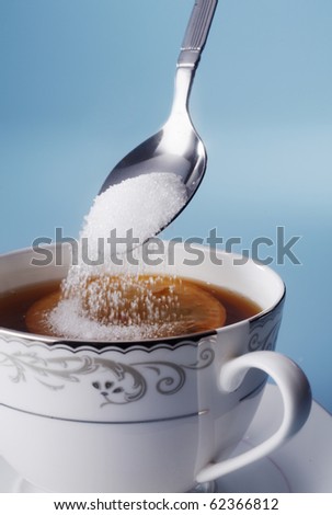 stock image of adding sugar to tea