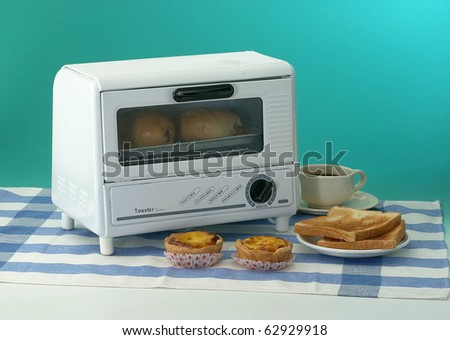 A toaster oven heats a tray of delicious buns.