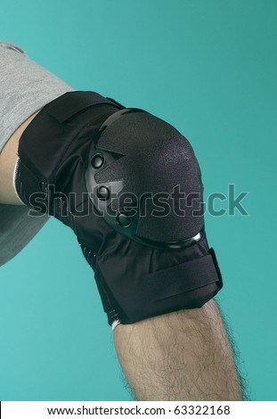 Male leg with textile knee pad on it