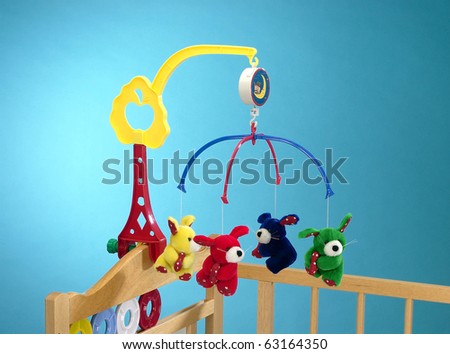 Hanging toy attached to a baby cot