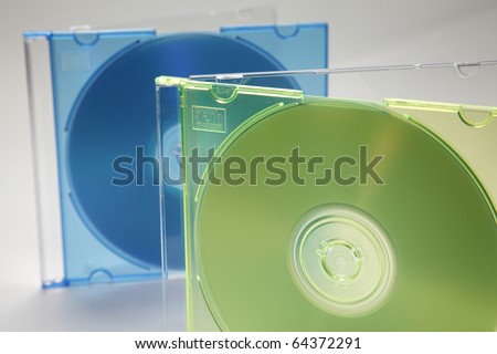 Two computer or music cd with green and blue cd case and blank label