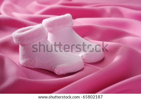 Pink socks isolated on a pink cloth.