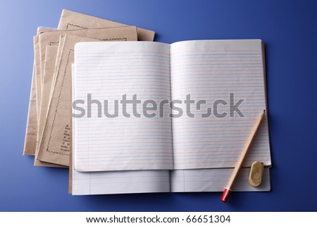 Loads of exercise books isolated on the blue background.