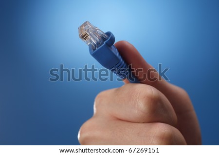 Human hand holding an Internet connection cable.