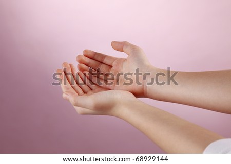 Human hand performing begging gesture.