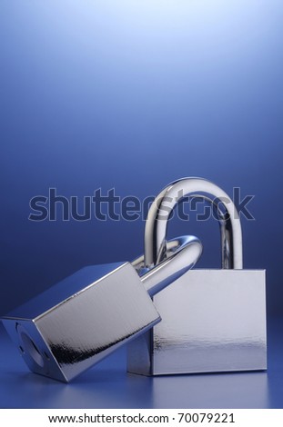 Two padlocks interlocked together on the background.