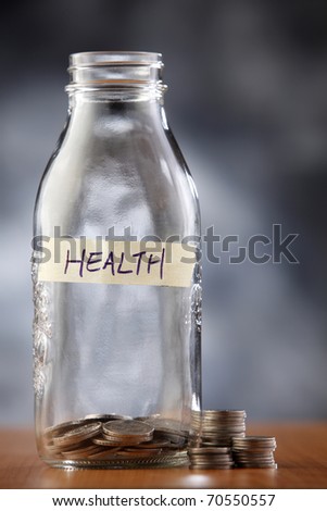 Bottle label health with a few coins.