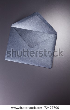 Black envelope isolated on the black background.