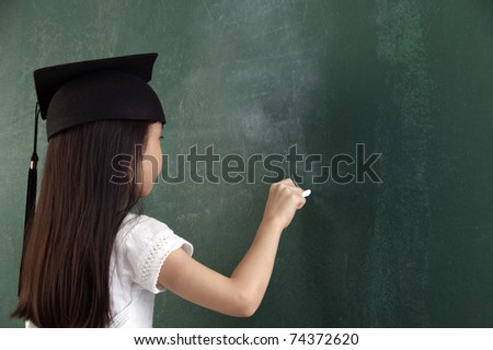 girl with the mortar board writting with chalk