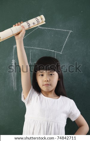 girl holding certificate in front of blackboard