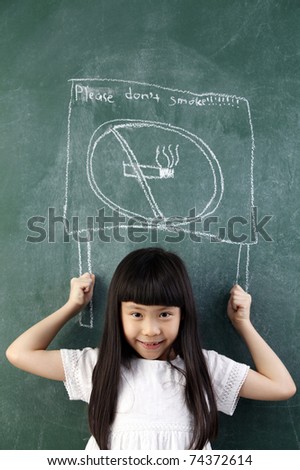 girl pretend holding a no smoking sign on black board