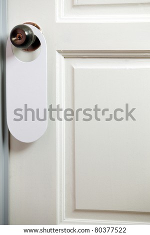 blank door tag hanging on the door knob