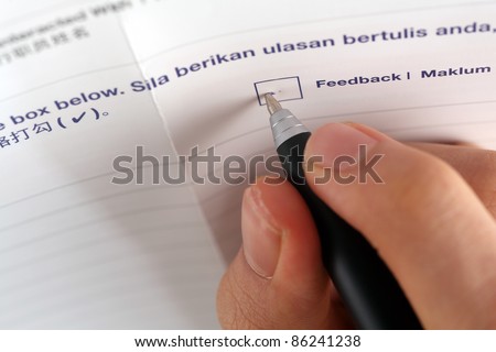 pen marking check boxes, close up