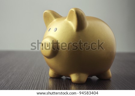 single object golden piggy bank on the table top