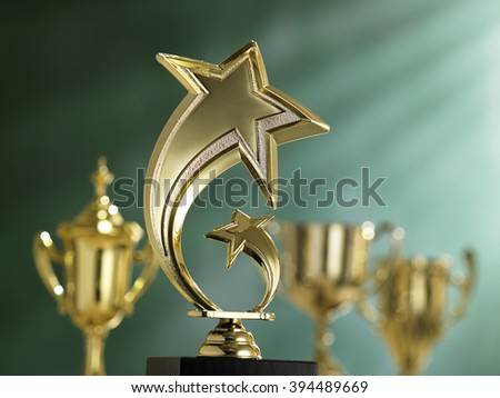 group trophies in front of blackboard with light ray effect