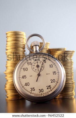 stop watch with stack of coin