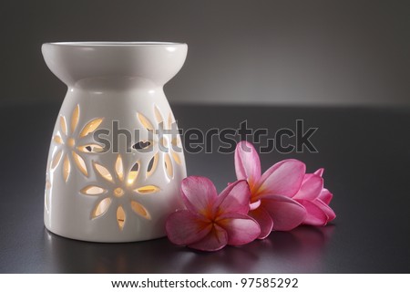 oil burner with the frangipani flower by the side