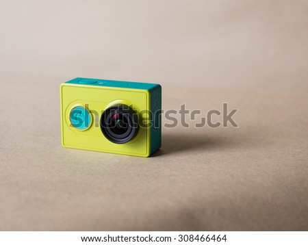 Xiaomi Yi Action Camera light green color on brown paper background
