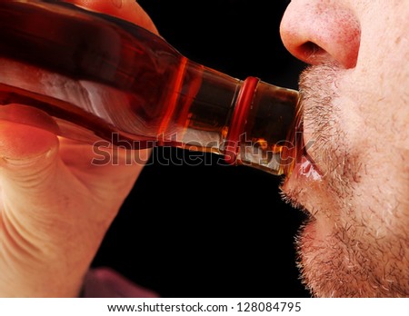 Close Up of a Man Drinking Hard Liquor from the Bottle