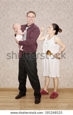 Father holding his Crying Baby and being Scalded by his Angry Wife
