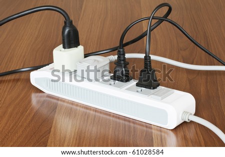 Tangled power cords plugged into a power board