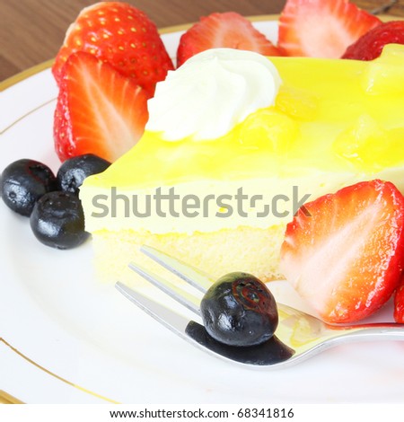 Freshly baked fruit flavored cheese cake with cream